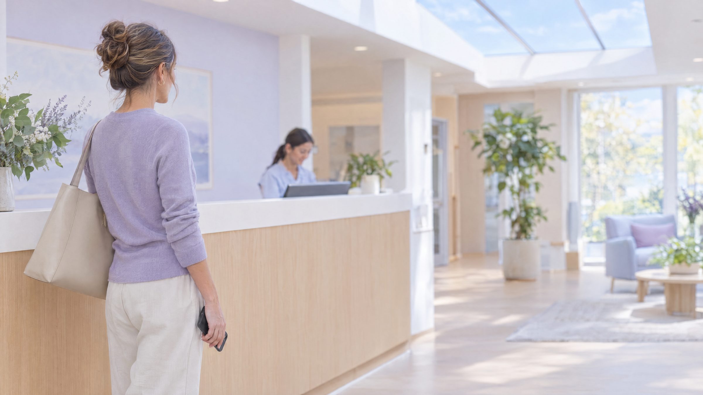 Woman with a tote bag at the front desk of a bright clinic