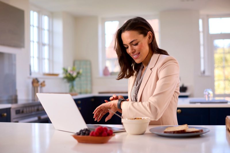 A woman checking her health metrics at home in the morning